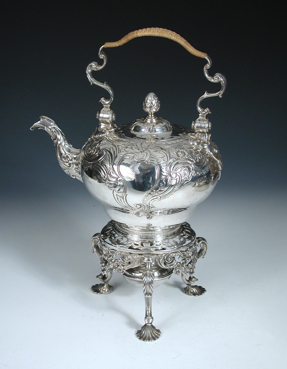 A silver tea kettle on stand, by George Methuen, London 1750, the upper compressed globular body