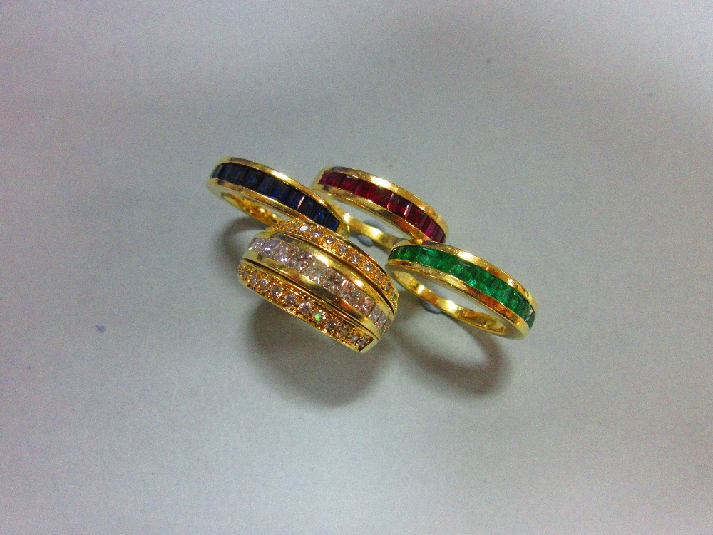 An interchangeable diamond, ruby, emerald and sapphire half band eternity ring, with four