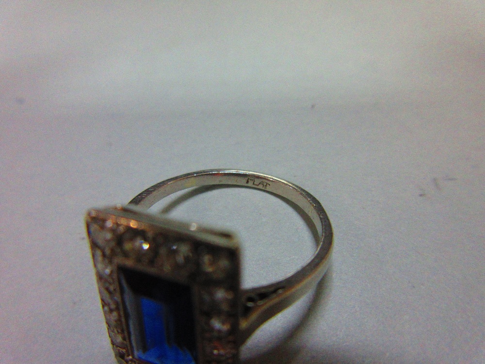 A mid 20th century sapphire and diamond ring, the rectangular step cut royal blue sapphire in a - Image 5 of 6