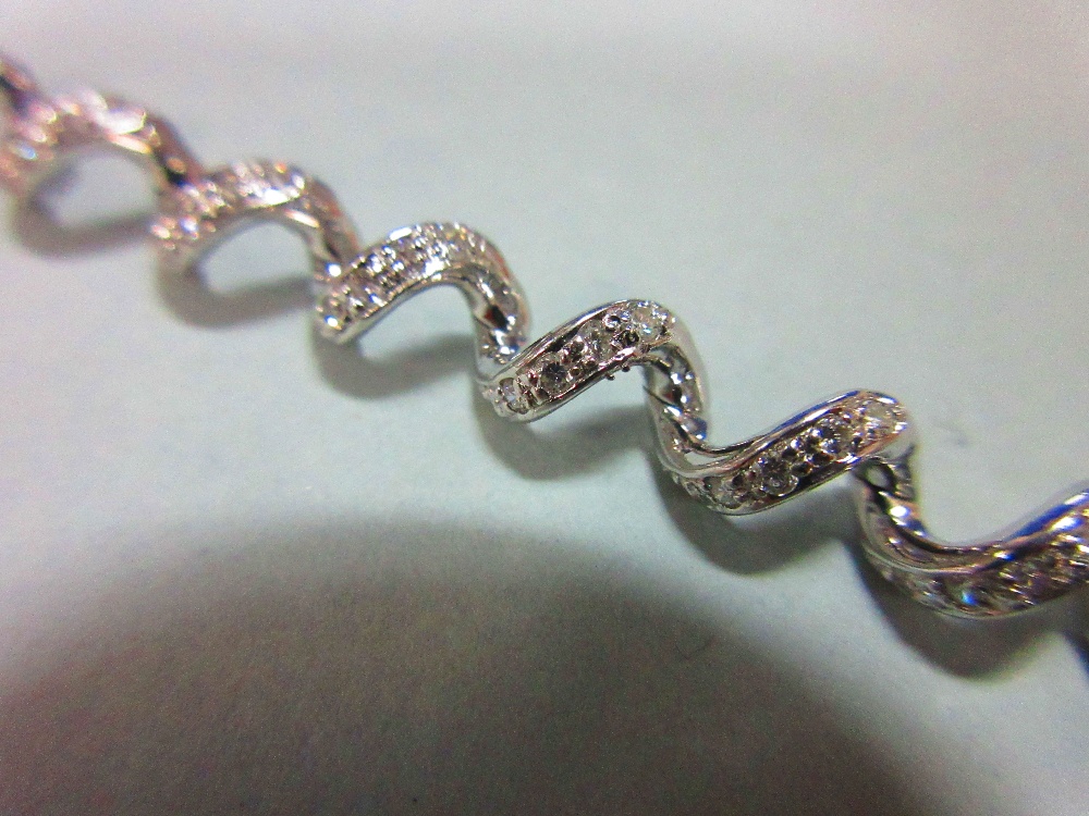 A spiral link diamond bracelet, the continuous smooth line of links forming an open centre - Image 2 of 4