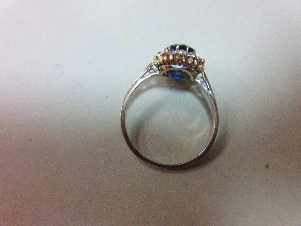 A sapphire and diamond cluster ring, the round cut sapphire in a border of old variously round cut - Image 3 of 5