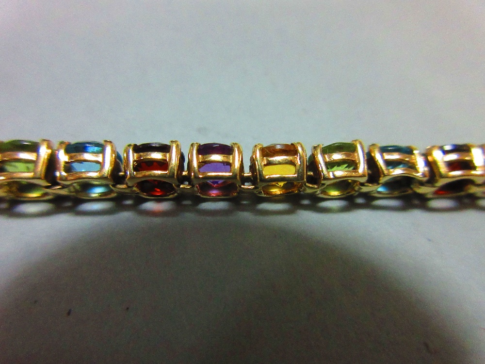 A multi-coloured gem set line bracelet, the uniform round cut gems, to include garnet, blue topaz, - Image 6 of 6