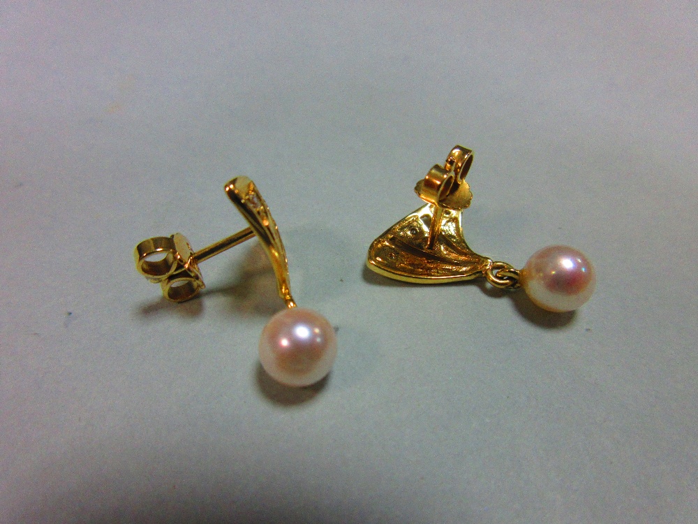 A pair of pearl and diamond earstuds, each with a pierced triangular fan motif set with three - Image 2 of 3
