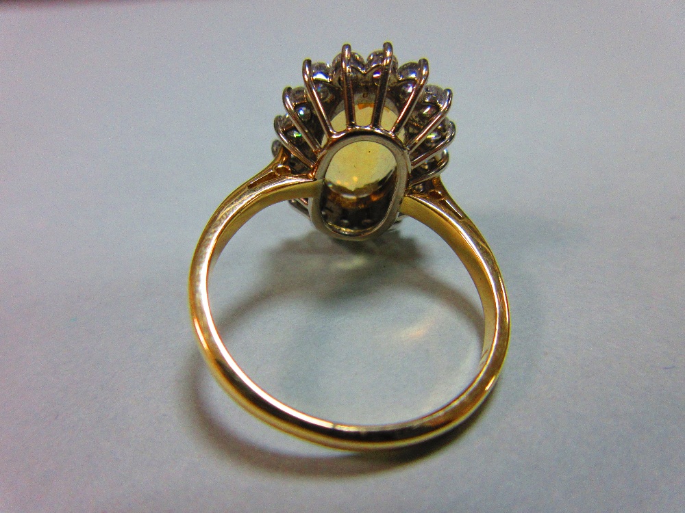 A topaz and diamond cluster ring, the oval mixed cut golden topaz claw set to a border of eighteen - Image 4 of 5