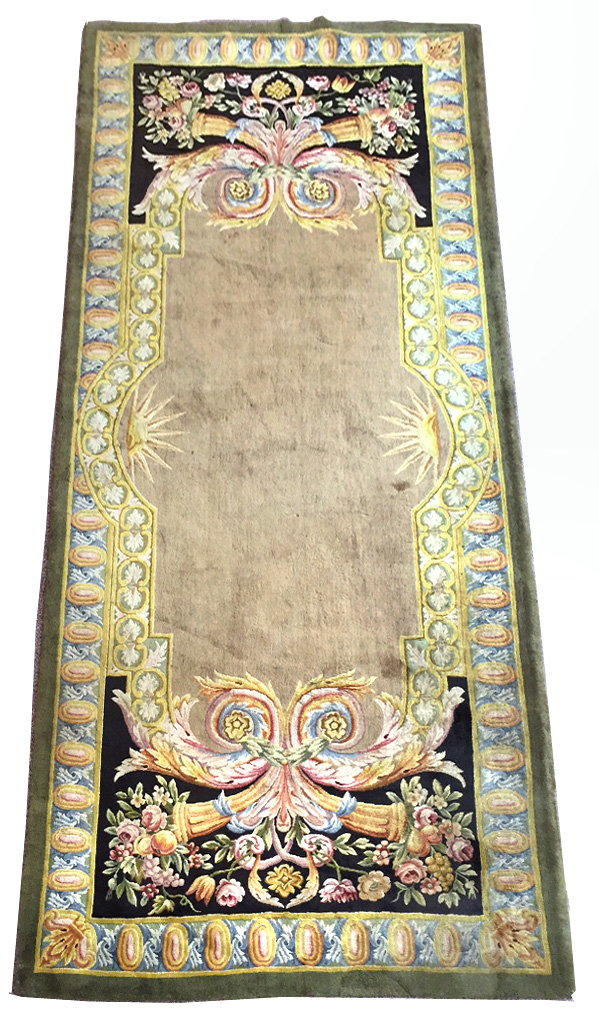 A Savonnerie style green ground rug, 345 x 147cm (135 x 57in) Good colours and good levels of