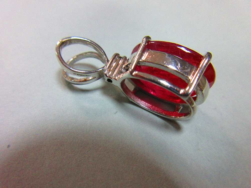 A treated ruby and diamond pendant set in white 18ct gold, the oval cut ruby four claw set beneath a - Image 3 of 5