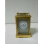 A miniature French porcelain panel gilt brass carriage timepiece, with gilt decorated pale blue