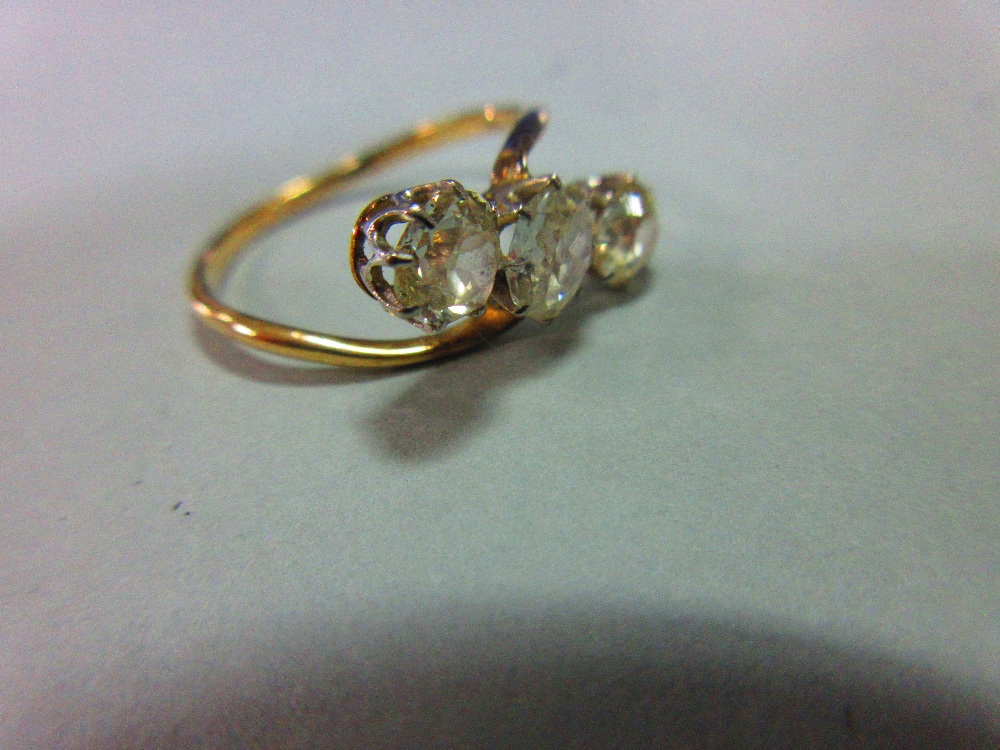 A three stone diamond ring, the three old cushion cut diamonds claw set in a diagonal line to a fine - Image 6 of 6