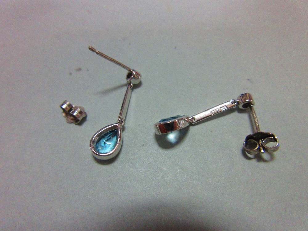 A pair of blue topaz, diamond and white gold earpendants, each post headed by a collet set round - Image 2 of 3