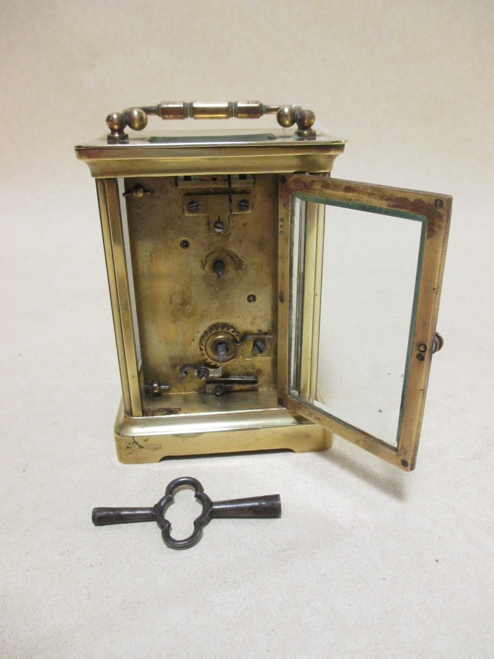 A brass cased carriage clock with white dial and black Roman numerals, 11.5cm high handle down - Image 4 of 4