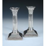 A pair of dwarf silver candlesticks, by James Kebberling Bembridge (Hawksworth, Eyre & Co Ltd),