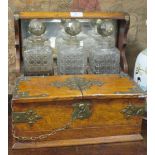 A Victorian oak cased and compartment tantalus, with brass gothic mounts enclosing three