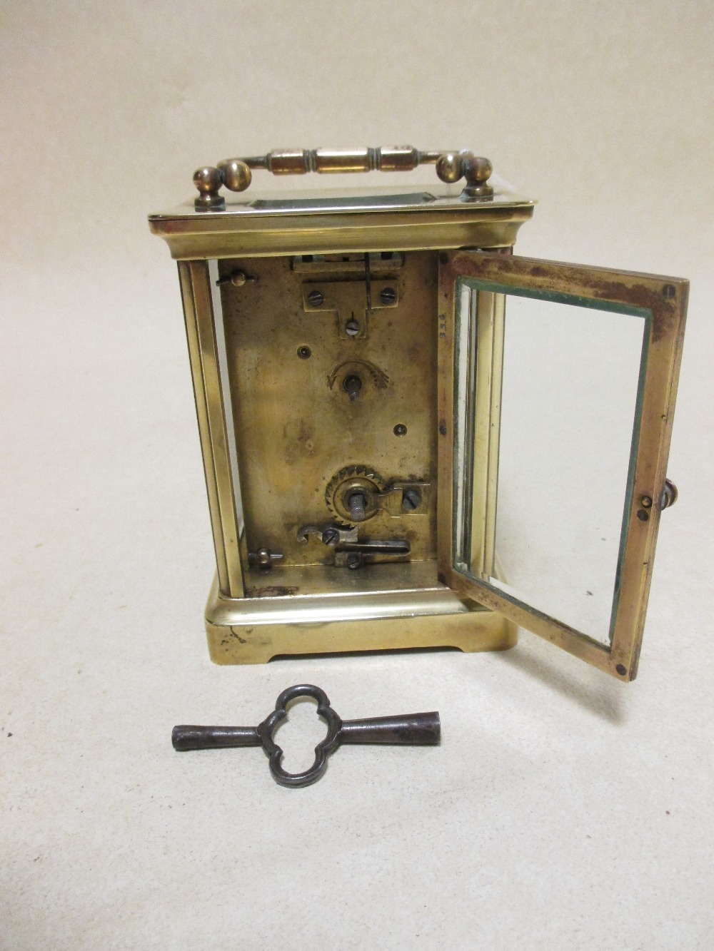 A brass cased carriage clock with white dial and black Roman numerals, 11.5cm high handle down - Image 3 of 4