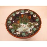 A Continental majolica wall charger, relief moulded with frogs in a lilly pond  Losses to lillypad