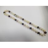 A strand of pink, dark grey and white pearls, 48cm long, with a bi-coloured silver gilt heart shaped