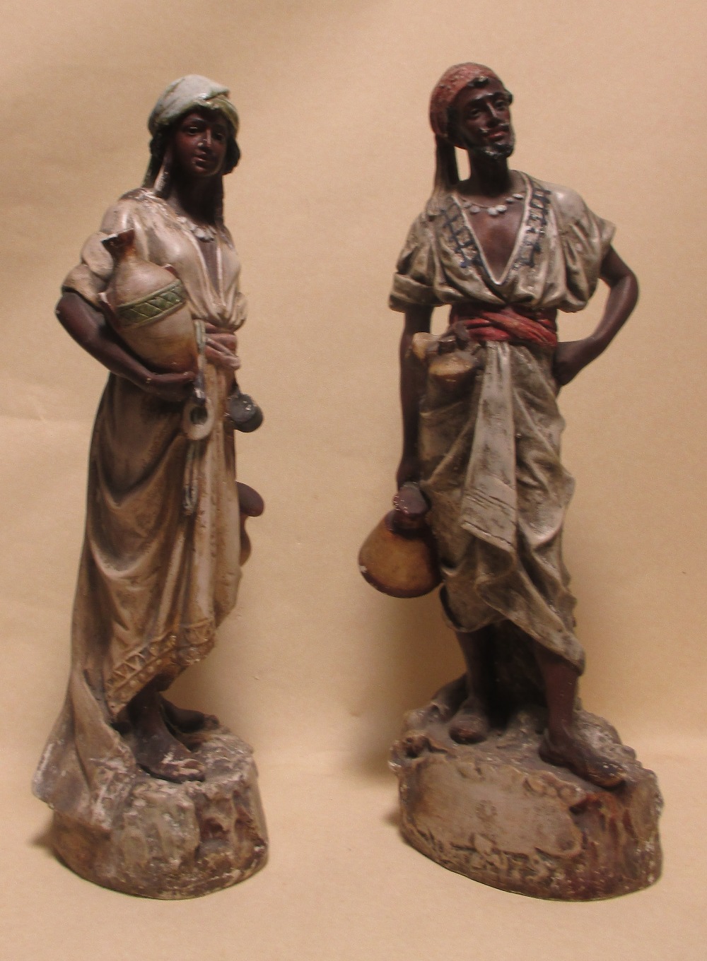 A pair of early 20th century Continental plaster Blackamoor figures of water carriers, tallest