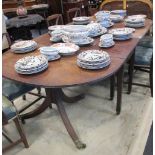 A late George III mahogany D end dining table, with central section on square section legs, brass