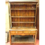 A small 18th century oak dresser, with boarded plate rack, two drawers and open pot board, 122cm