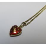 A Faberge pendant, the heart shaped red enamel and gold pendant with '2000' diagonally across the