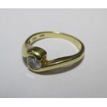 An 18ct solitaire ring, the round brilliant cut diamond, approx. 0.3cts, in a rubover setting of