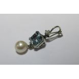 An aquamarine and pearl pendant, the emerald cut aquamarine claw set in unmarked white metal, with a