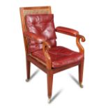 A Regency mahogany library bergere, the arms upholstered in red leather, cane seat with loose