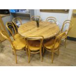 A set of eight bentwood cafe chairs, together with a pine extending pedestal dining table, 116cm