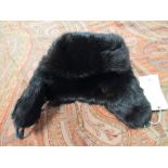 A deep brown fur trapper hat