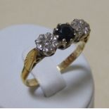 An 18ct sapphire and gypsy set diamond ring, size P and a three stone opal and sapphire cluster