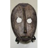 A Lega mask from the Democratic Republic of Congo, 24cm long