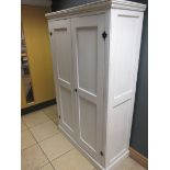 A panelled two door cupboard, painted white with black painted hinges, 183 x 116 x 48cm