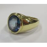 A gentleman's ring with oval cut mystic topaz in rub over setting, yellow precious metal stamped 14k