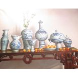 An oil on canvas of blue and white Chinese vases and kumquats on an altar table, signed Anuame, 76 x