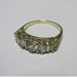 A five stone diamond ring, the graduated old cut stones set to a raised gallery and tapering band,