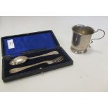 A silver christening mug set London, 1923, 2.8 oz, together with a christening knife and fork set (