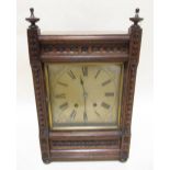 A late 19th century brass dial 8 day mantle clock in associated carved oak case