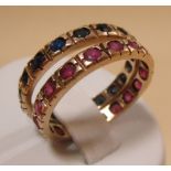 A pair of sapphire and ruby full hoop rings, the small round stones in rubover settings, both set in