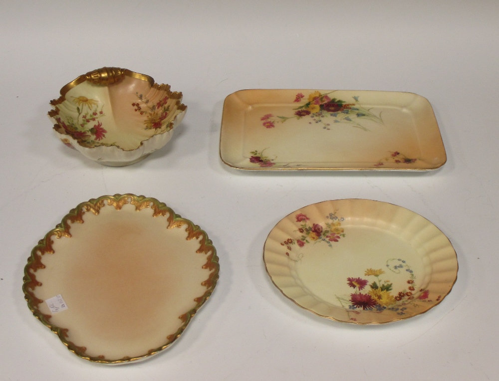 A Royal Worcester shell shaped bowl decorated with flowers, puce mark 12 dots, 19cm long, and