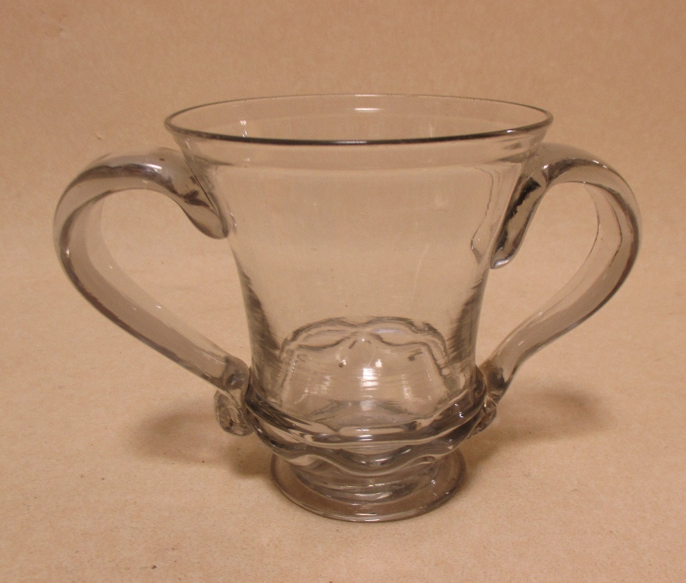 A mid 18th century two handled mug together with a European two handled covered bowl, the thistle
