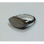 A white and champagne coloured diamond ring, the navetter shaped top pave set with white diamonds to
