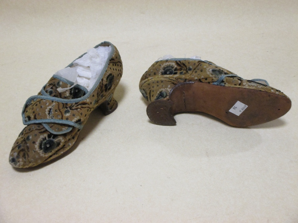 A pair of late 17th century ladies silk slippers, the late ground with blue borders and flowers - Image 2 of 2