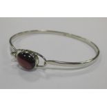 A three row pear shaped garnet cabochon and silver necklace, a garnet pendant necklace, a garnet