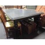 A reproduction black painted extending dining table, 76 x 114 x 260cm