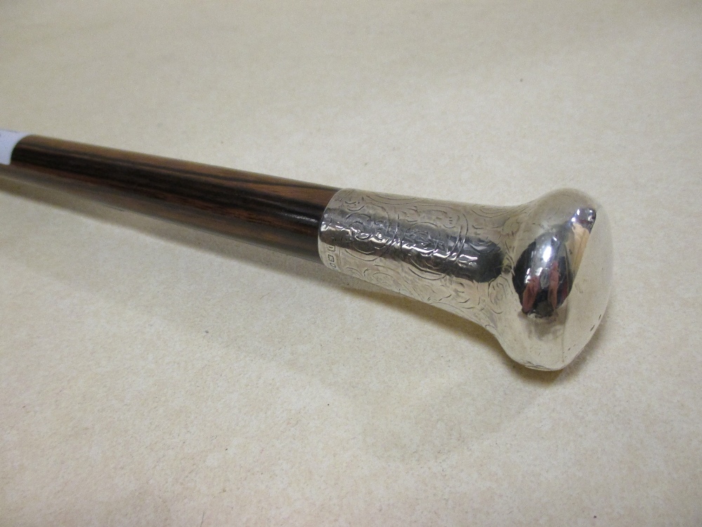 A silver mounted hardwood walking cane, another with silver cap, a walking cane, stick and