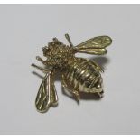 A 9ct gold bee brooch, a pale green hardstone fly brooch, a square pale pink cameo and two
