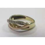 An 18ct tri-coloured gold and diamond crossover ring, size N-O