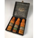 Ahmed Soliman, a cased set of three treen cased perfume bottles, each of turned boxwood with