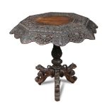 An Indian carved blackwood pedestal table, octagonal top decorated with birds and animals on a