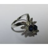 A contemporary sapphire and diamond 'wishbone' cluster ring, the two oval claw set sapphires