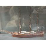 A model three masted sailing ship, 56cm wide, in a glazed case 73cm wide overall, circa 1900